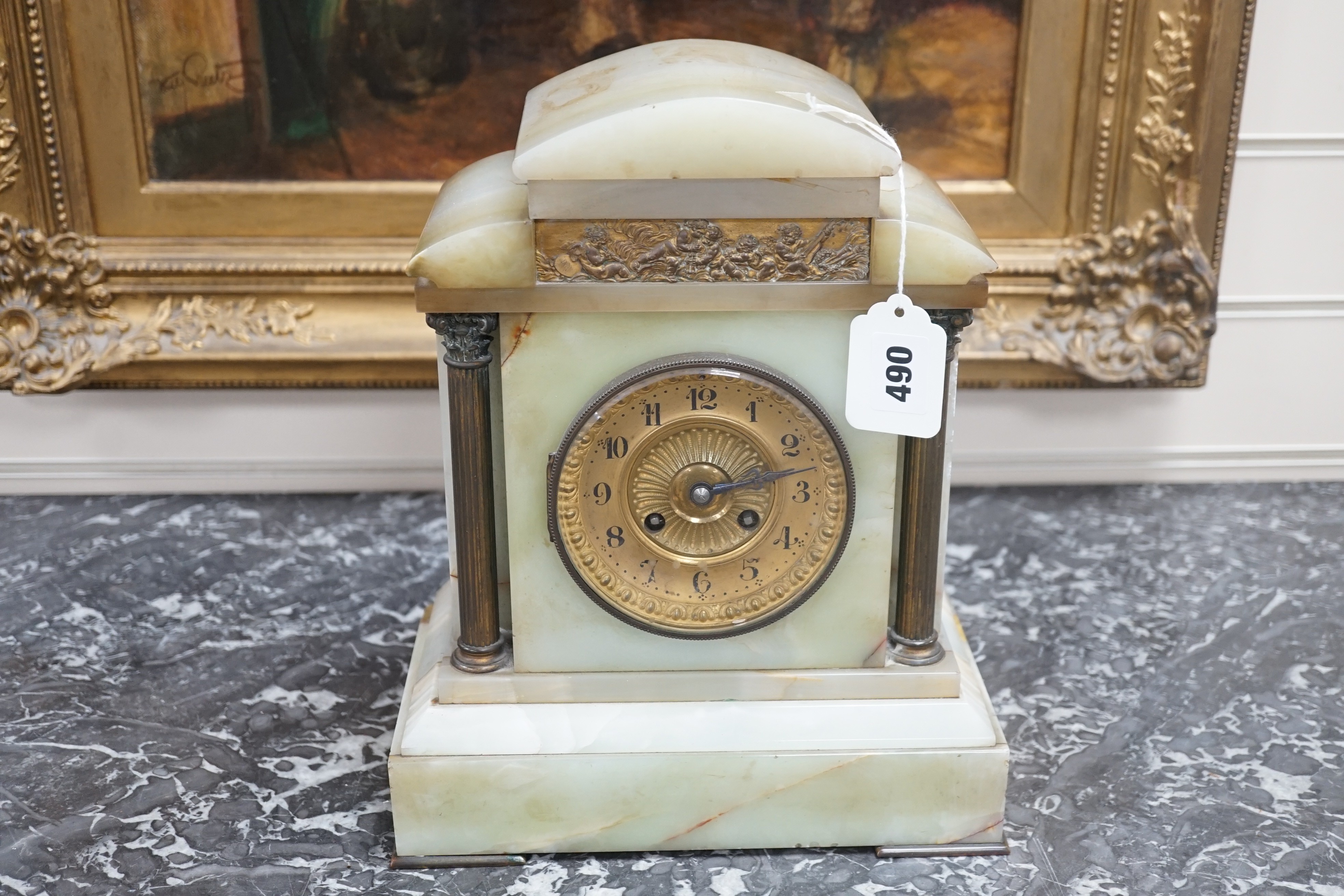 An early 20th century green onyx and brass mounted mantle clock-31.5 cms high.